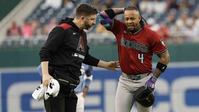 Arizona Diamondbacks' Ketel Marte (4) is checked by a trainer after an apparent leg injury after hitting a double off Washington Nationals pitcher Jake Irvin during the first inning of a baseball game in Washington, Friday, April 4, 2025. (Terrance Williams/AP)