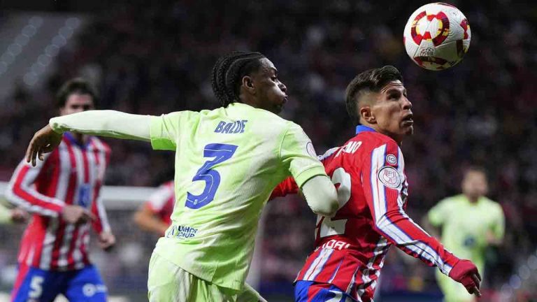 Barcelona's Alejandro Balde, left, and Atletico Madrid's Giuliano Simeone fight for the ball during the Spanish Copa del Rey semifinal second leg soccer match between Atletico Madrid and Barcelonaat the in Madrid, Spain, Wednesday, April 2, 2025. (Manu Fernandez/AP)