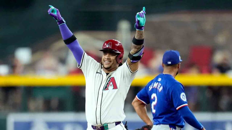 Arizona Diamondbacks' Ketel Marte, left, celebrates his double as Texas Rangers second baseman Marcus Semien (2) looks away during the first inning of a baseball game Wednesday, Sept. 11, 2024, in Phoenix. (Ross D. Franklin/AP)