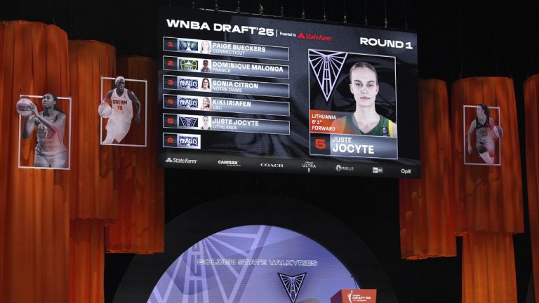 Juste Jocyte is shown on a screen after being picked fifth overall by the Golden State Valkyries during the first round of the WNBA basketball draft, Monday, April 14, 2025, in New York. (AP Photo/Pamela Smith)
