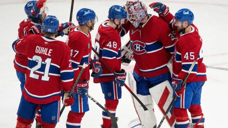 Montreal Canadiens surround goaltender Sam Montembeault (35) to celebrate their win over Detroit Red Wings following third period NHL hockey action in Montreal on Tuesday, April 8, 2025. (Christinne Muschi/AP)
