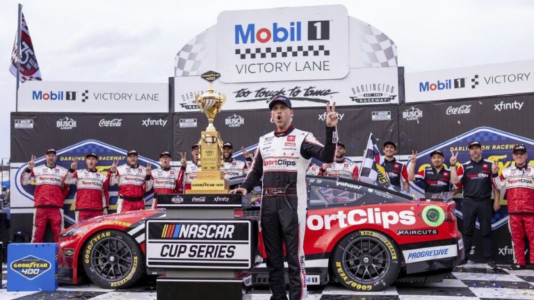 Denny Hamlin celebrates on Victory Lane after winning a NASCAR Cup Series auto race at Darlington Raceway, Sunday, April 6, 2025, in Darlington, S.C. (AP/Scott Kinser)