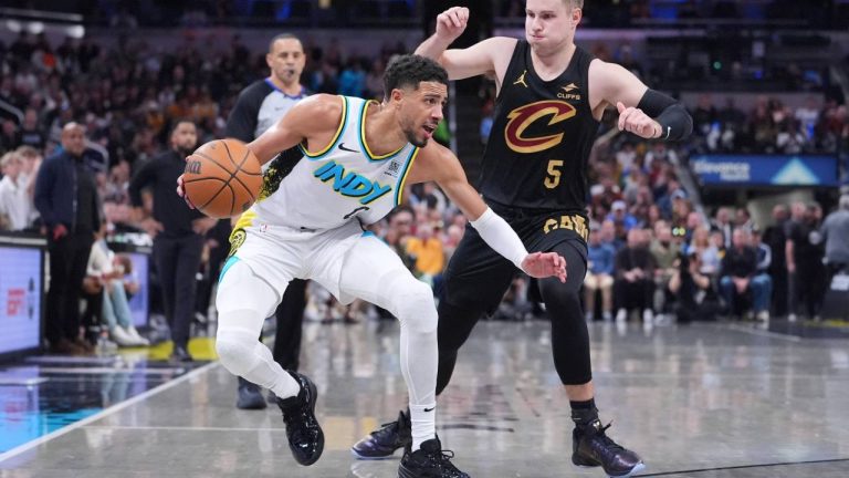 Indiana Pacers guard Tyrese Haliburton (0) drives on Cleveland Cavaliers guard Sam Merrill (5) during the second half of an NBA basketball game. (Michael Conroy/AP)