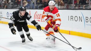 Los Angeles Kings defenceman Brandt Clarke, left, and Calgary Flames centre Morgan Frost vie for the puck during the first period of an NHL hockey game Thursday, April 17, 2025, in Los Angeles. (Mark J. Terrill/AP)