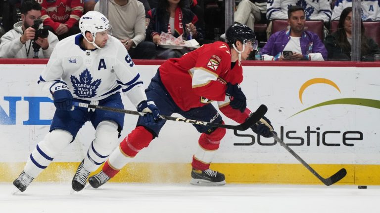 Toronto Maple Leafs centre John Tavares (91) and Florida Panthers defenseman Niko Mikkola (77) go for the puck during the first period of an NHL hockey game, Tuesday, April 8, 2025, in Sunrise, Fla. (Lynne Sladky/AP)