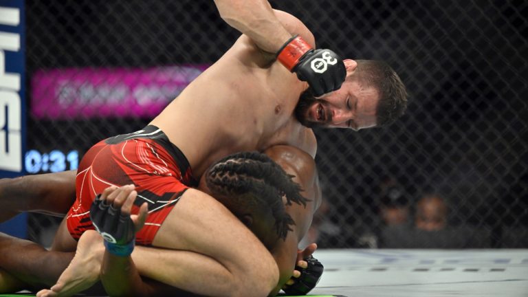 Mateusz Gamrot, top, punches Jalin Turner during a UFC 285 mixed martial arts lightweight bout in Las Vegas. (David Becker/AP)