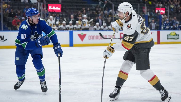 Vegas Golden Knights' Shea Theodore (27) takes a shot on goal as Vancouver Canucks' Vittorio Mancini (90) defends during the second period of an NHL hockey game in Vancouver, on Wednesday, April 16, 2025. (Darryl Dyck/CP)