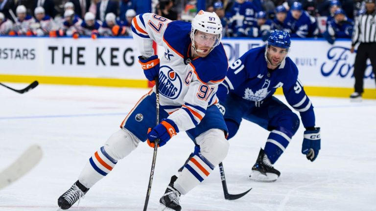 Edmonton Oilers centre Connor McDavid (97) attacks the net while defended by Toronto Maple Leafs centre John Tavares (91) during first period NHL action, in Toronto, Saturday, Nov. 16, 2024. (Christopher Katsarov/CP)