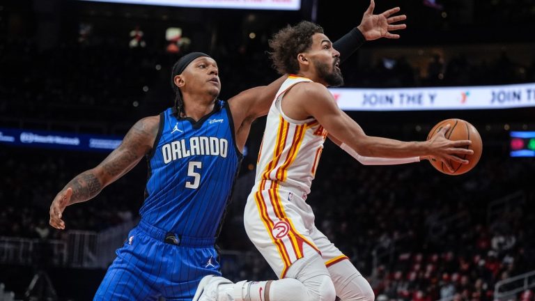 Atlanta Hawks guard Trae Young gets by Orlando Magic forward Paolo Banchero during the first half of an NBA game, Thursday, Feb. 20, 2025, in Atlanta. (AP/Mike Stewart)