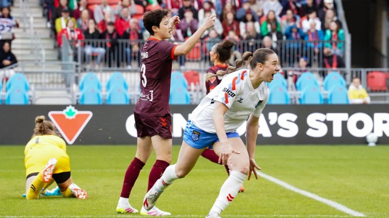 Montreal Roses FC forward Tanya Boychuk (12) celebrates scoring a goal as AFC Toronto defender Hong Hye-ji (3) reacts during first half Northern Super League soccer action in Toronto on Saturday, April 19, 2025. (Arlyn McAdorey/CP)