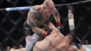 Josh Emmett punches an opponent during a featherweight mixed martial arts bout at a UFC Fight Night event in Sacramento, Calif., in 2019. (Jeff Chiu/AP)