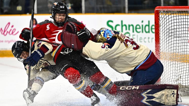 Montreal Victoire goaltender Ann-Renee Desbiens (35) uses her stick to push Ottawa's Jocelyne Larocque (23) from her crease, as Victoire's Kristin O'Neill (43) defends, during first period PWHL hockey action in Ottawa, on Saturday, Feb. 22, 2025. (Justin Tang/CP)