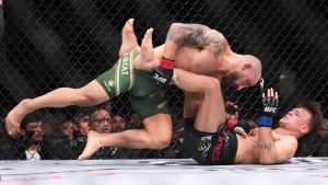 Alexander Volkanovski, left, and Diego Lopes, right, battle during a mixed martial arts fight at UFC 314, Sunday, April 13, 2025, in Miami. (Lynne Sladky/AP)