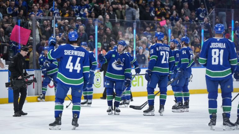 Vancouver Canucks' Quinn Hughes, back centre, and his teammates salute the crowd after playing the Vegas Golden Knights in their final NHL hockey game of the season, in Vancouver, on Wednesday, April 16, 2025. (Darryl Dyck/CP)