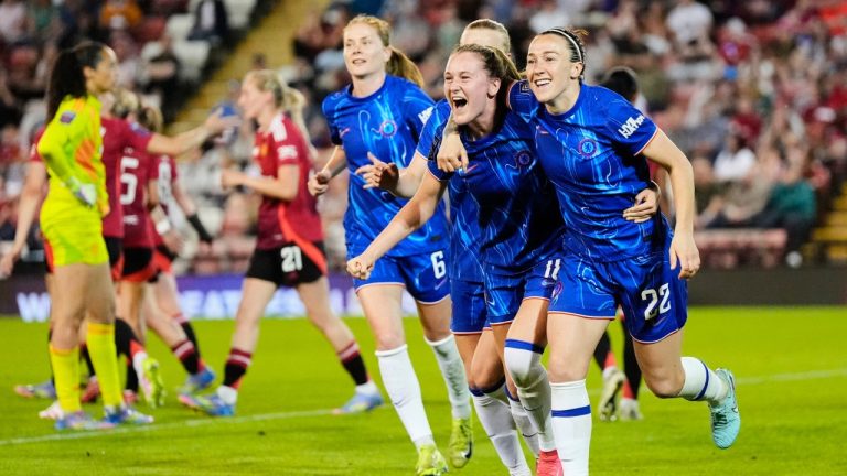 Chelsea's Lucy Bronze (22) celebrates with teammates after scoring their side's first goal of the game during the English Women's Super League soccer match between Manchester United and Chelsea at Leigh Sports Village in Manchester, England, Wednesday April 30, 2025. (Nick Potts/PA via AP)