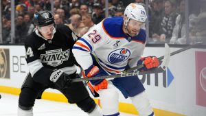 Los Angeles Kings defenceman Mikey Anderson, left, battles with Edmonton Oilers centre Leon Draisaitl during the first period in Game 2 of an NHL first-round playoff series Wednesday, April 23, 2025, in Los Angeles. (Mark J. Terrill/AP)