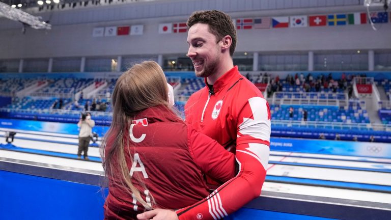 Canada's Brett Gallant hugs Jocelyn Peterman after winning the men's curling bronze medal match between Canada and the United States at the Beijing Winter Olympics Friday, Feb. 18, 2022, in Beijing. (Brynn Anderson/AP Photo)