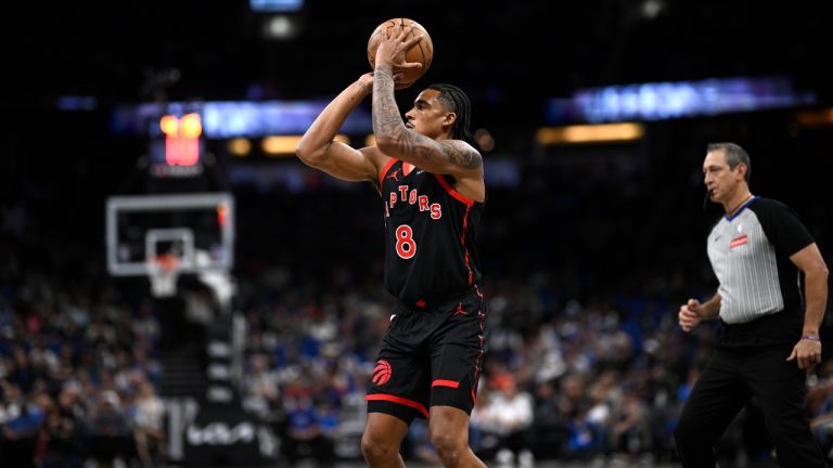 Toronto Raptors guard Jared Rhoden (8) goes up to shoot against the Orlando Magic during the second half of an NBA basketball game, Tuesday, March 4, 2025, in Orlando, Fla. (Phelan M. Ebenhack/AP)
