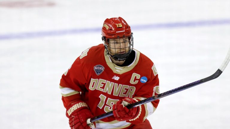 Denver forward Carter King (15) shoots during warmups prior to an NCAA hockey regionals game against Providence on Friday, March 28, 2025, in Manchester, N.H. (Greg M. Cooper/AP Photo)