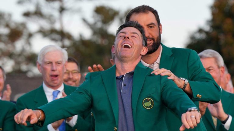 Scottie Scheffler puts the Green Jacket on winner, Rory McIlroy, of Northern Ireland, at the Masters golf tournament, Sunday, April 13, 2025, in Augusta, Ga. (David J. Phillip/AP Photo)