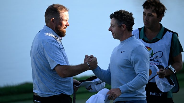 Shane Lowry, left, of Ireland, and Rory McIlroy, centre, of Northern Ireland, finish on the 18th green during the first round of the Arnold Palmer Invitational at Bay Hill golf tournament, Thursday, March 6, 2025, in Orlando, Fla. (Phelan M. Ebenhack/AP)