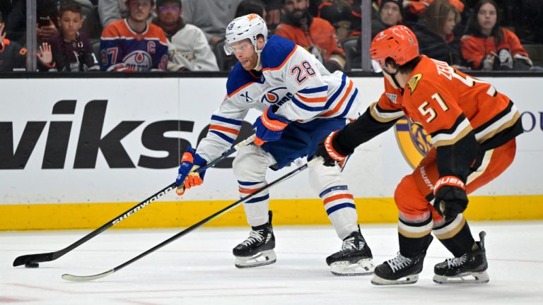Edmonton Oilers right wing Connor Brown (28) controls the puck away from Anaheim Ducks defenseman Olen Zellweger during the second period of an NHL hockey game Monday, April 7, 2025, in Anaheim, Calif. (Jayne Kamin-Oncea/AP)