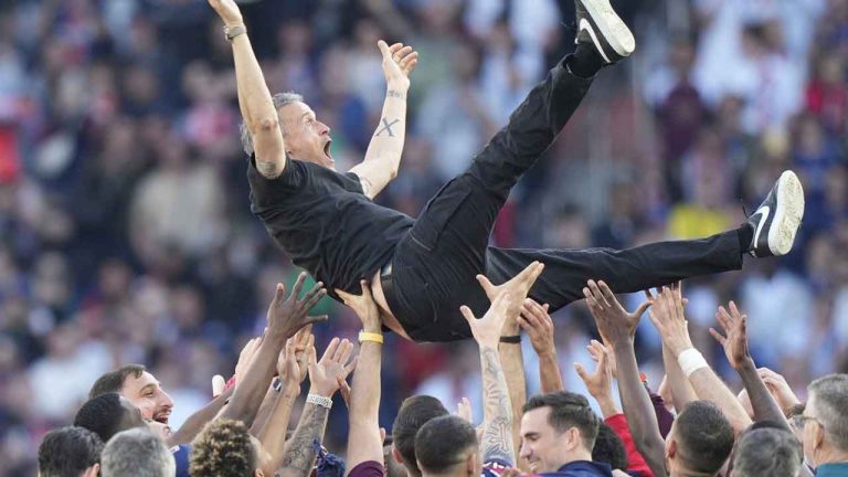 Paris Saint-Germain players throw PSG's head coach Luis Enrique in the air after they won the French League One soccer match between Paris Saint-Germain and Angers at Parc des Princes stadium. (Michel Euler/AP)