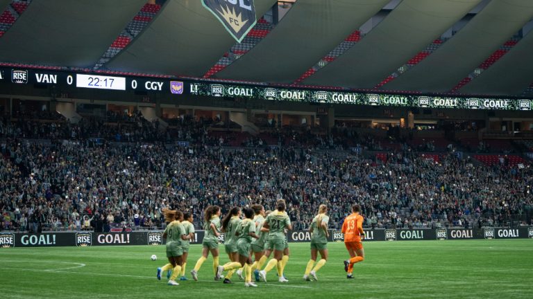 Fans celebrate after the Vancouver Rise score against the Calgary Wild during the first half of an NSL match in Vancouver on Wednesday, April 16, 2025. (Ethan Cairns/CP)