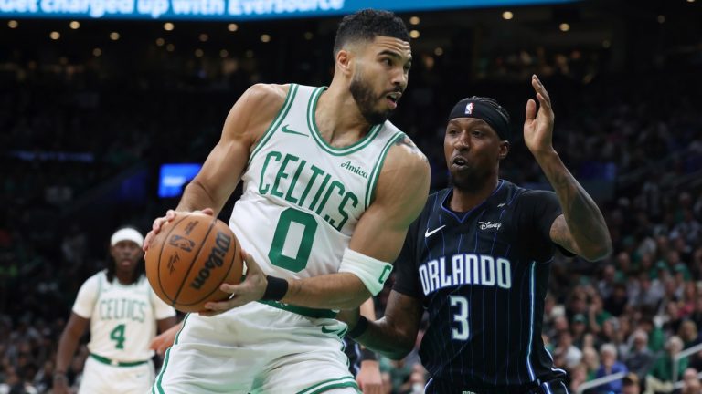 Boston Celtics' Jayson Tatum (0) drives past Orlando Magic's Kentavious Caldwell-Pope (3) during the first half in game 1 of a first-round NBA playoff basketball series Sunday, April 20, 2025, in Boston. (Michael Dwyer/AP)