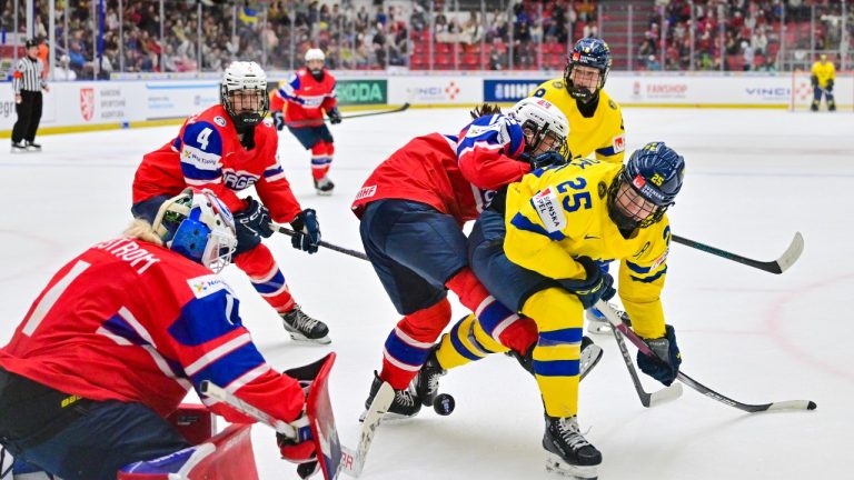 Norway's Oda Austefjord, second right, and Sweden's Lina Ljungblom, right, challenge for the puck during the IIHF Women's World Championship, Group B, ice hockey match between Norway and Sweden in Ceske Budejovice, Czech Republic, Tuesday, April 15, 2025. (Vaclav Pancer/CTK via AP)