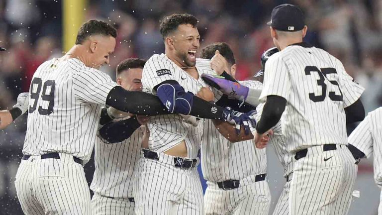 New York Yankees' J.C. Escarra, center, celebrates with teammates after hitting a walk-off sacrifice fly ball during the 10th inning of a baseball game against the San Diego Padres Wednesday, May 7, 2025, in New York. (Frank Franklin II/AP)