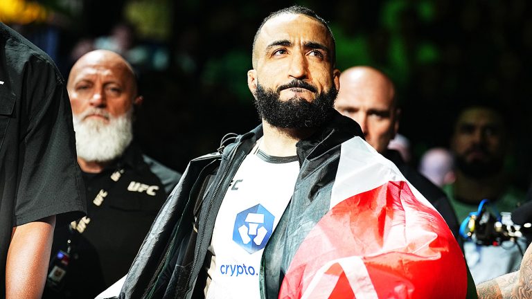 Belal Muhammad walks to the Octagon carrying the flag of Palestine ahead of a UFC welterweight championship bout. (Chris Unger/Zuffa LLC via Getty)