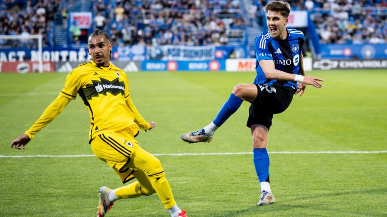 CF Montreal's Luca Petrasso (13) scores while Columbus Crew's Mohamed Farsi (23) defends during first half MLS soccer action, in Montreal on Wednesday, May 14, 2025. (Christopher Katsarov/CP)