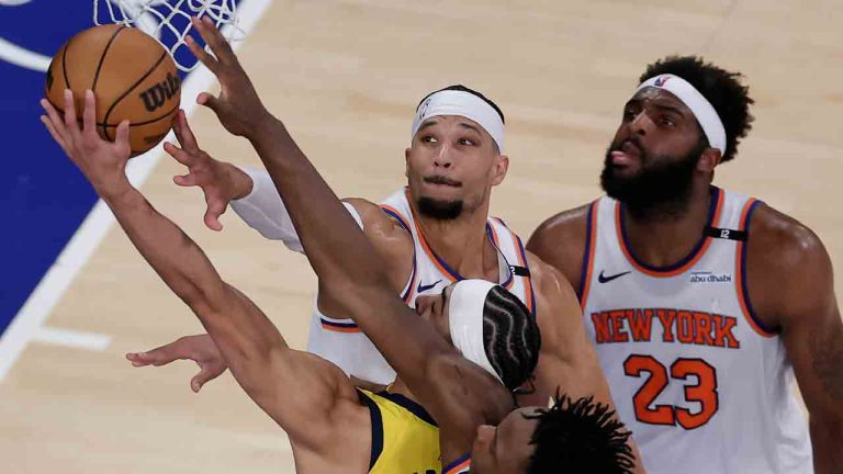 Indiana Pacers guard Andrew Nembhard (2) puts up a shot against New York Knicks guard Josh Hart (3) and guard Miles McBride (2) during the second quarter of Game 2 of the NBA basketball Eastern Conference final, Friday, May 23, 2025, in New York. (Adam Hunger/AP)