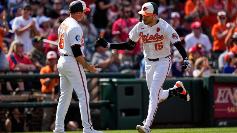 Baltimore Orioles' Dylan Carlson celebrates with interim third base/infield coach Buck Britton, after hitting a three-run home run during the fourth inning of a game against the St. Louis Cardinals, Monday, May 26, 2025. (AP Photo/Stephanie Scarbrough)
