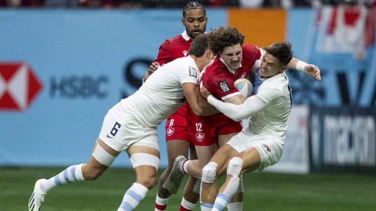 Argentina's Santiago Alvarez and Marcos Moneta tackle Canada's David Richard as Josiah Morra watches from behind during Vancouver Sevens rugby action in Vancouver on Friday, Feb. 23, 2024. (THE CANADIAN PRESS/Ethan Cairns)
