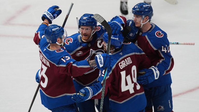 Colorado Avalanche defenseman Samuel Girard (49) is congratulated after scoring a goal by, from left, right wing Valeri Nichushkin, left wing Gabriel Landeskog (92) and defenseman Josh Manson in the third period of Game 4 of an NHL hockey first-round playoff series Saturday, April 26, 2025, in Denver. (David Zalubowski/AP)