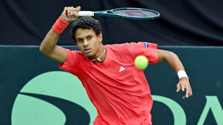 Gabriel Diallo, of Canada, plays a shot to Fabian Marozsan, of Hungary, during their Davis Cup qualifying tennis match in Montreal on Sunday, February 2, 2025. (THE CANADIAN PRESS/Graham Hughes)