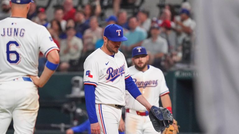 Texas Rangers pitcher Luke Jackson, center, walks to the mound after getting hit by a line drive during the ninth inning of a baseball game against the Colorado Rockies. (LM Otero/AP)