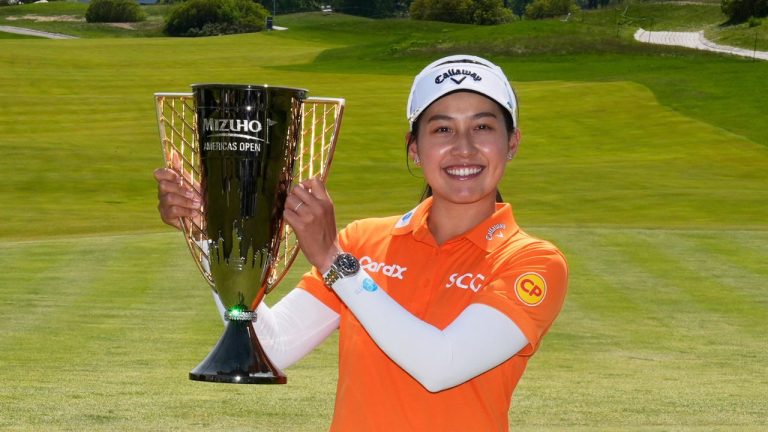 Jeeno Thitikul, of Thailand, poses with her trophy after winning the Mizuho Americas Open LPGA golf tournament, Sunday, May 11, 2025, in Jersey City, N.J. (Seth Wenig/AP)