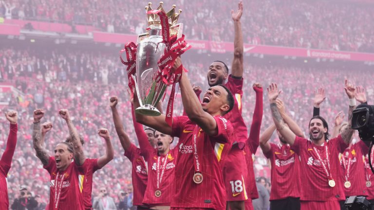 Liverpool's Trent Alexander-Arnold holds the winner's trophy as he celebrates with teammates after the English Premier League soccer match between Liverpool and Crystal Palace at the Anfield stadium in Liverpool, England, Sunday, May 25, 2025. (Jon Super/AP)