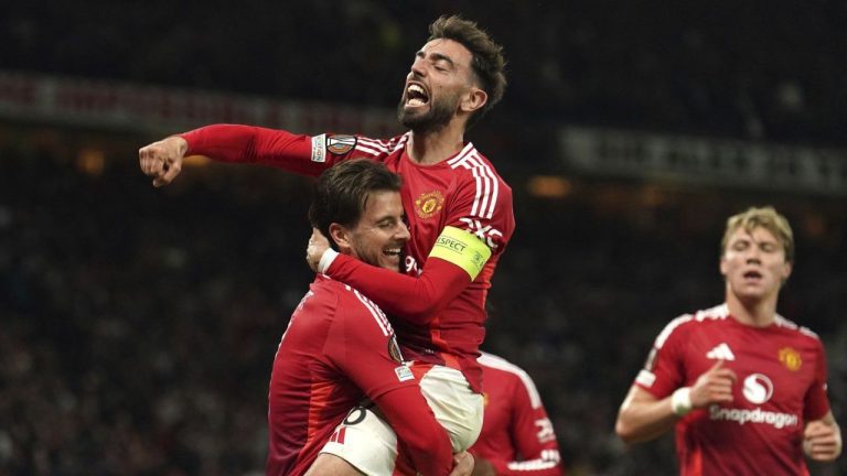Manchester United's Mason Mount, left, celebrates with Bruno Fernandes after scoring their first goal of the game during the Europa League semifinal second leg soccer match between Manchester United and Athletic Bilbao in Manchester, Britain, Thursday, May 8, 2025. (Martin Rickett/PA via AP)
