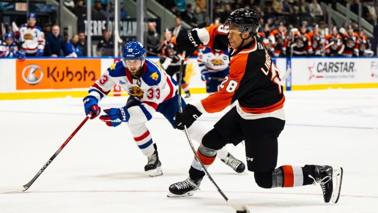 Medicine Hat Tigers' Cayden Lindstrom (28) shoots on net while defended by Moncton Wildcats' Loke Johansson (33) during third period Memorial Cup hockey action, in Rimouski, Que., Monday, May 26, 2025. (Christopher Katsarov/CP)