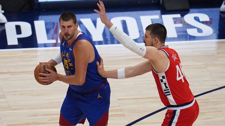 Denver Nuggets center Nikola Jokic, left, looks to pass the ball as Los Angeles Clippers center Ivica Zubac, right, defends in the first half of Game 7 of an NBA basketball first-round playoff series Saturday, May 3, 2025, in Denver. (David Zalubowski/AP)