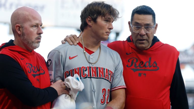 Cincinnati Reds outfielder Tyler Callihan (32) is helped off the field after colliding with the wall during the third inning of a baseball game against the Atlanta Braves, Monday, May 5, 2025, in Atlanta. (Butch Dill/AP)