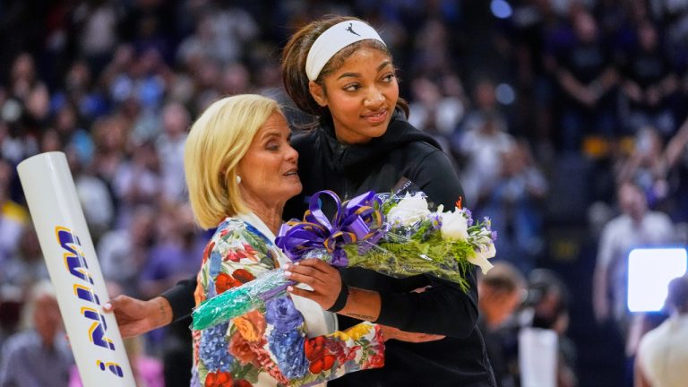 Chicago Sky forward Angel Reese hugs her former coach, LSU's Kim Mulkey, as she presents Reese flowers before a WNBA exhibition basketball game against Brazil in Baton Rouge, La., Friday, May 2, 2025. (Gerald Herbert/AP)