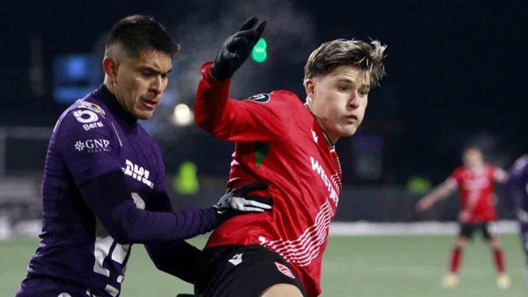 Cavalry FC's Tobias Warschewski holds off Pumas UNAM's Ricardo Galindo during second half soccer action in round one of the 2025 CONCACAF Champions Cup in Langford, B.C., on Thursday, February 6, 2025. (Chad Hipolito/CP)