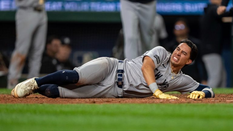 New York Yankees' Oswaldo Cabrera reacts after injuring his leg while scoring a run during the ninth inning of a baseball game against the Seattle Mariners, Monday, May 12, 2025, in Seattle. (Stephen Brashear/AP)