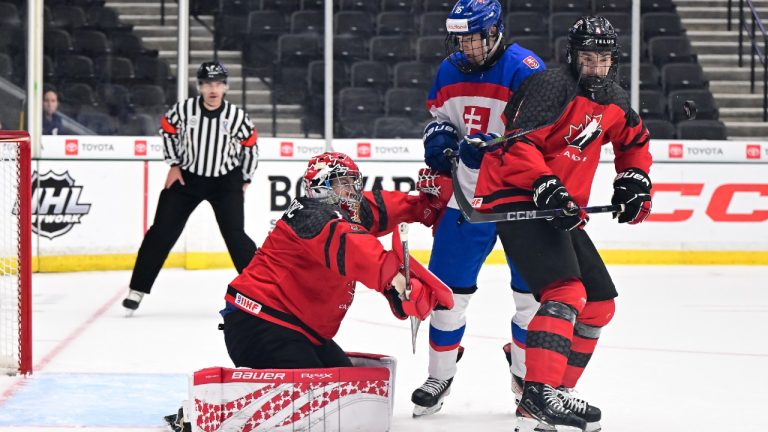 Canada goaltender Jack Ivankovic makes a save as defenceman Ryan Lin, right, battles with Slovakia's Lukas Tomka during men's under-18 world hockey championship semifinal hockey action in Frisco, Texas in this Friday, May 2, 2025 handout photo. THE CANADIAN PRESS/HO, IIHF, Tim Austen