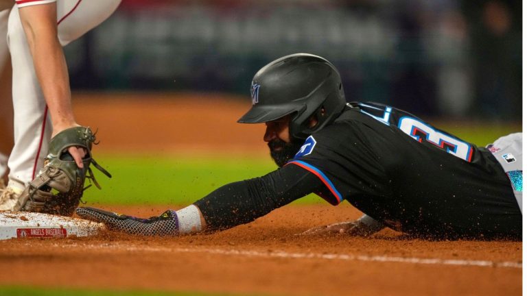 Miami Marlins' Derek Hill dives back to first ahead of the tag of Los Angeles Angels first baseman Nolan Schanuel during the seventh inning of a baseball game Saturday, May 24, 2025, in Anaheim, Calif. (Mark J. Terrill/AP)